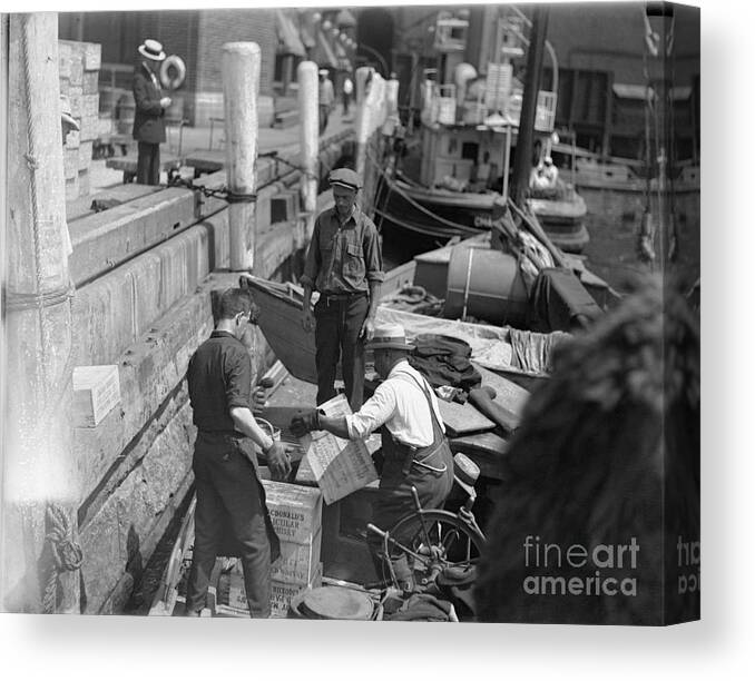People Canvas Print featuring the photograph Men Unloading Crates Of Rum by Bettmann