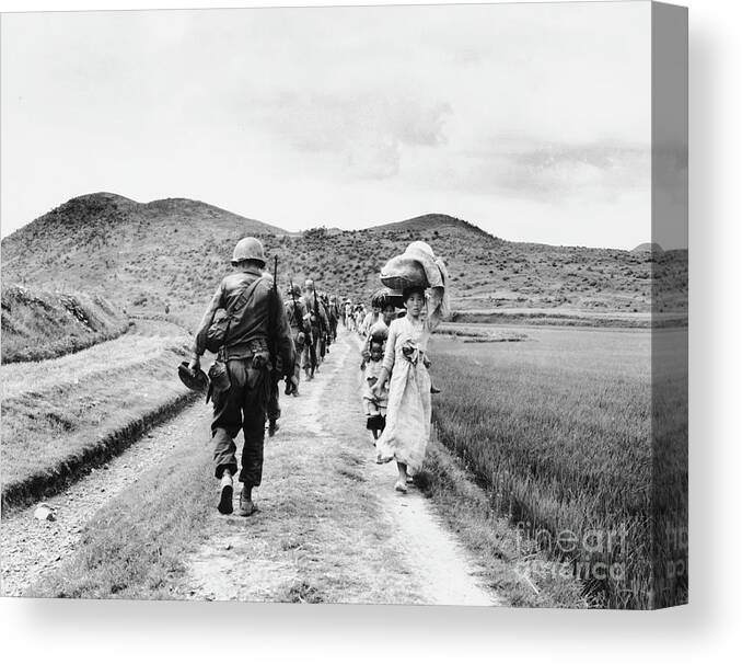 Marching Canvas Print featuring the photograph Soldiers And Refugees by Bettmann