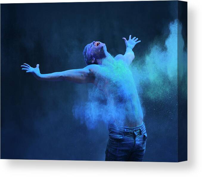 Art Canvas Print featuring the photograph Young Man In Spray Of Colored Powder by Henrik Sorensen
