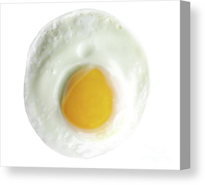 Sunny Side Canvas Print featuring the photograph Single egg, sunny side up, isolated on white, perfect yolk in ce by Pete Klinger