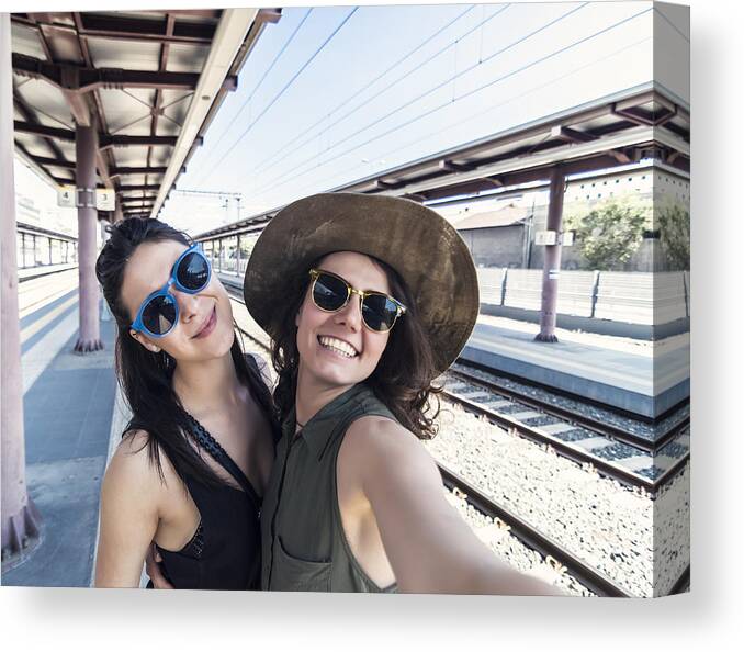 Cool Attitude Canvas Print featuring the photograph Two girlfriends in a train station by Elitsa Deykova