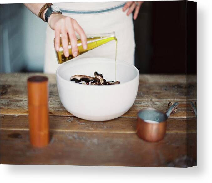 Material Canvas Print featuring the photograph A Domestic Kitchen. A Woman Wearing An by Mint Images - Britt Chudleigh