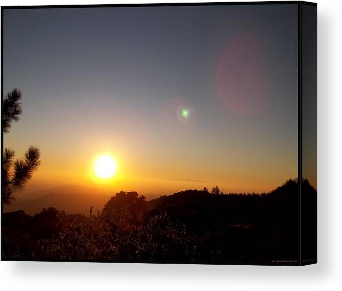 Western Sunset Canvas Print featuring the photograph As The Sun Sets In The West by Glenn McCarthy Art and Photography