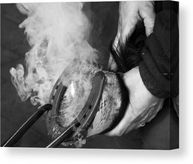 Blacksmith Canvas Print featuring the photograph Blacksmith with horseshoe - traditional craft by Matthias Hauser