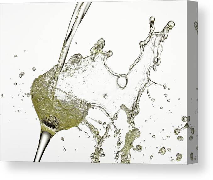 White Background Canvas Print featuring the photograph Champagne Being Poured Into Glass by Andy Roberts