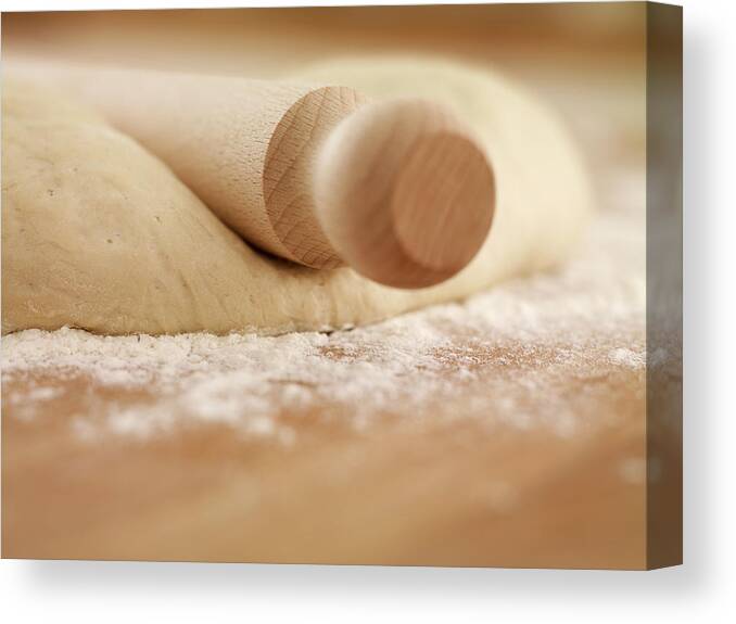 Rolling Pin Canvas Print featuring the photograph Close Up Of Rolling Pin On Dough by Adam Gault
