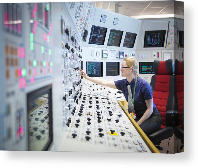 Working Canvas Print featuring the photograph Female operator in nuclear power station control room simulator by Monty Rakusen