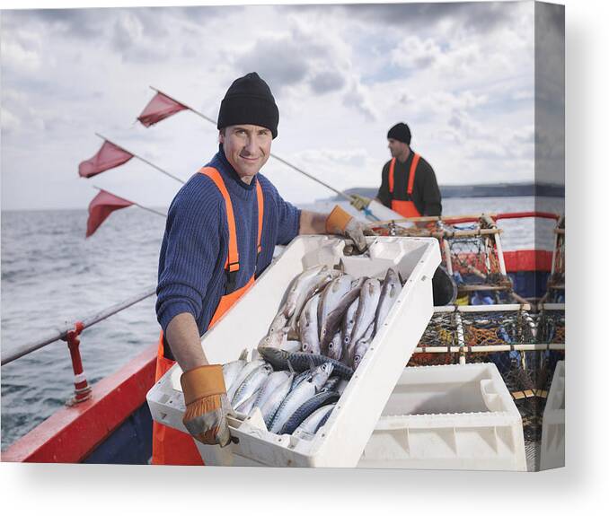 Working Canvas Print featuring the photograph Fishermen on boat with catch of fish by Monty Rakusen