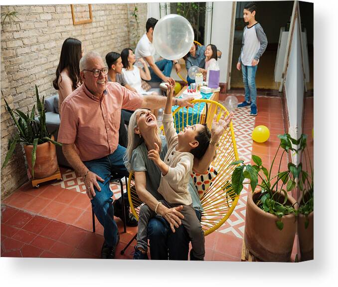 Toddler Canvas Print featuring the photograph Happy mexican grandparents and grandson playing with balloon by Aldomurillo