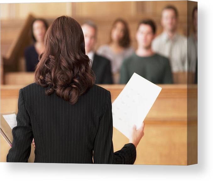 Mid Adult Women Canvas Print featuring the photograph Lawyer holding document and speaking to jury in courtroom by Chris Ryan