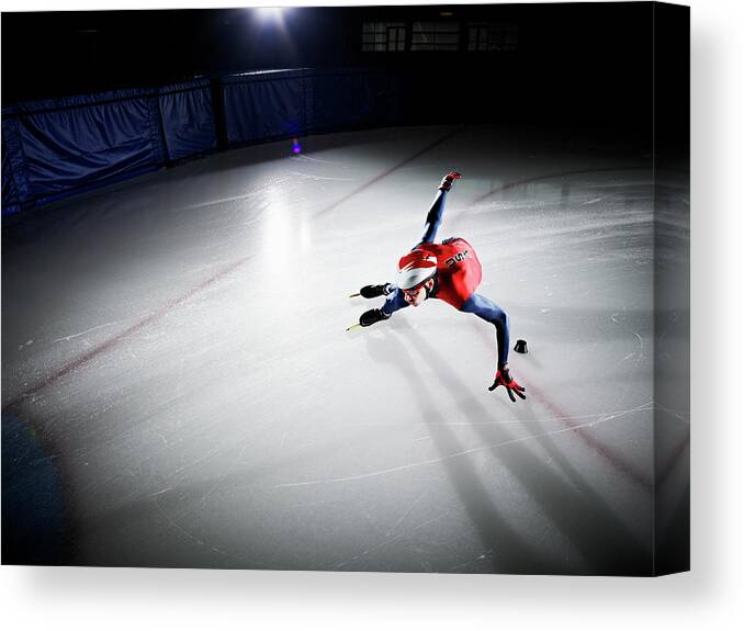 Sports Helmet Canvas Print featuring the photograph Short Track Speed Skater Making Turn by Thomas Barwick
