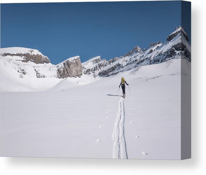 Scenics Canvas Print featuring the photograph Skier Lays New Track Across Snowslope by Ascent Xmedia
