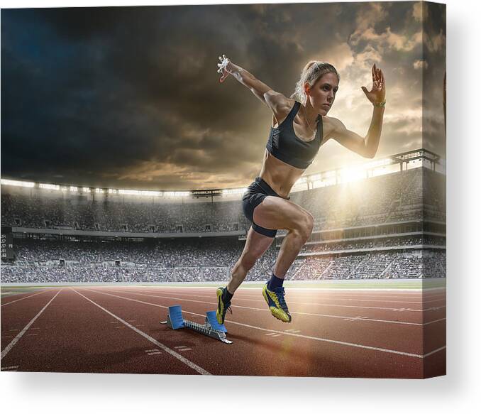 Event Canvas Print featuring the photograph Woman Sprinter in Mid Action Bursting From Blocks During Race by Peepo
