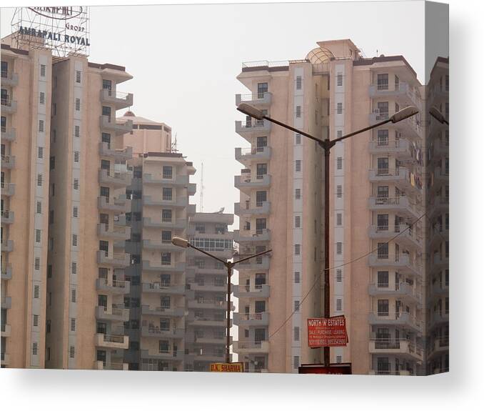 Apartment Canvas Print featuring the photograph Light poles in front of some multi-storey apartments in Noida in India by Ashish Agarwal