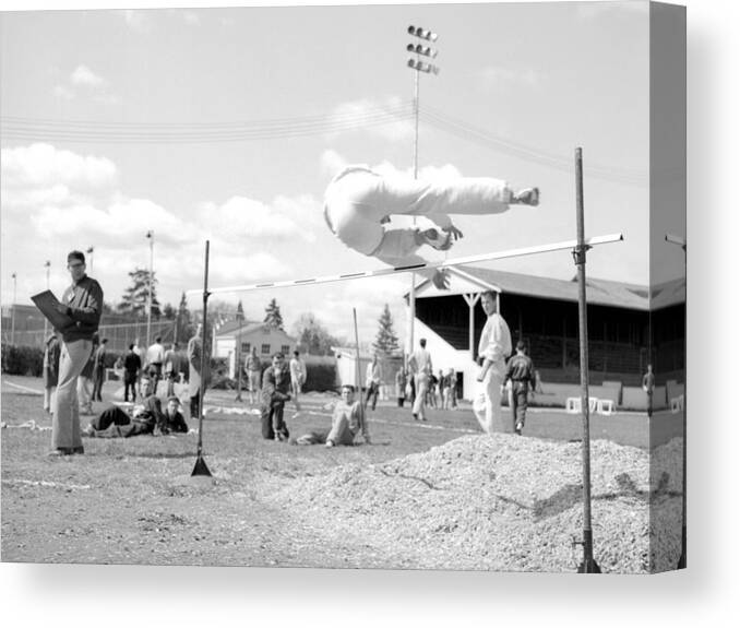 Boy Canvas Print featuring the photograph Boy Going Over High Jump Bar 1957 Black White by Mark Goebel