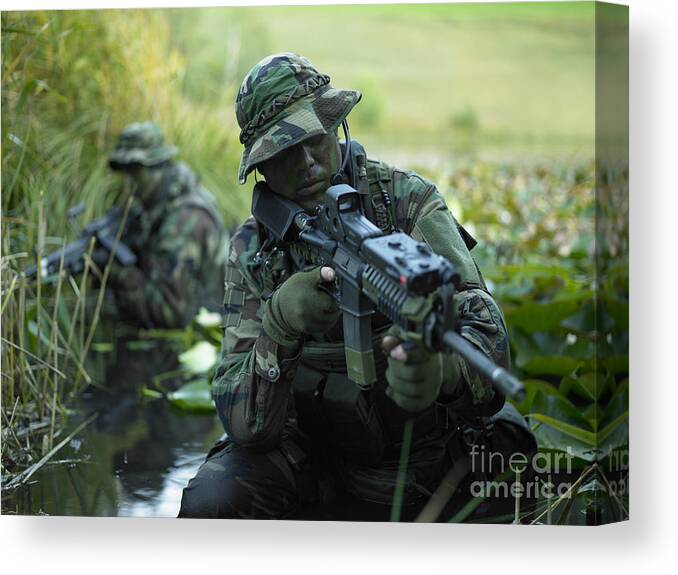 Special Operations Forces Canvas Print featuring the photograph U.s. Navy Seals Cross Through A Stream by Tom Weber