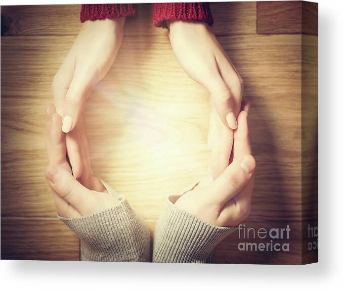 Hands Canvas Print featuring the photograph Woman and man making circle with hands. Warm light inside by Michal Bednarek