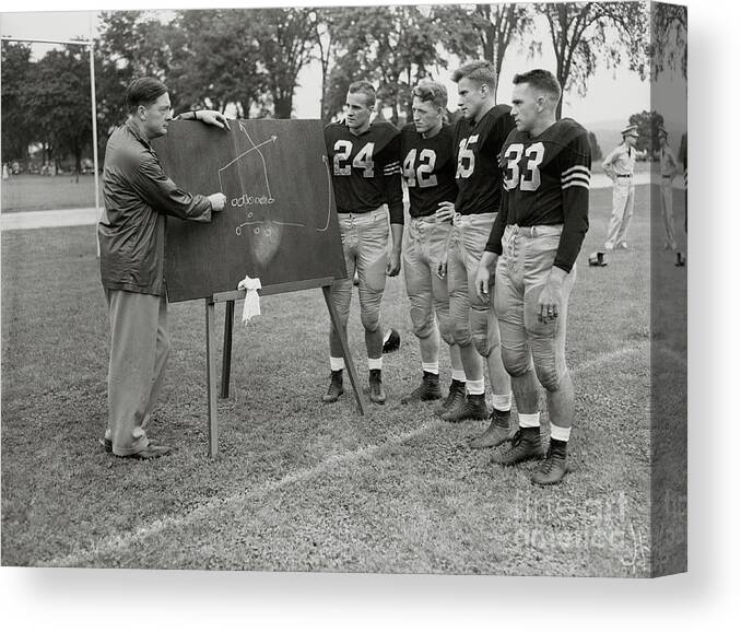Young Men Canvas Print featuring the photograph Coach Teaching Army Football Team by Bettmann