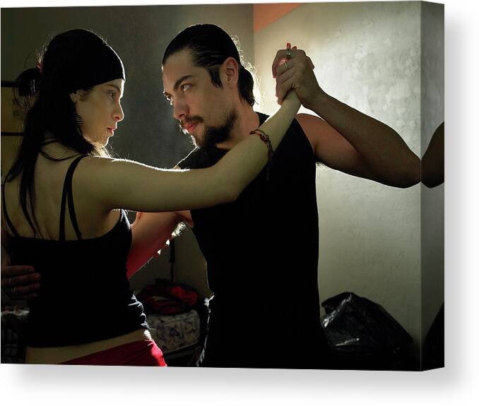 Shadow Canvas Print featuring the photograph Couple Practising Tango In Dark Room by Hans Neleman