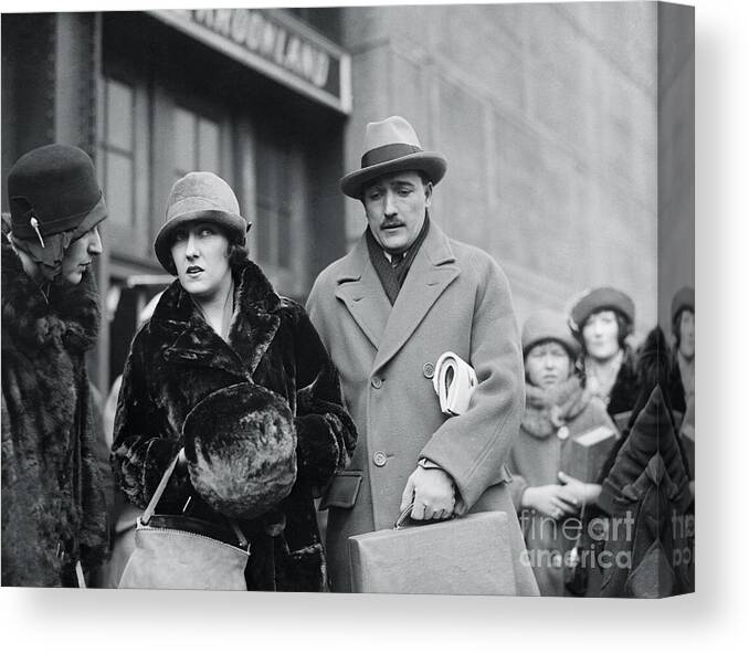 People Canvas Print featuring the photograph Gloria Swanson Standing With Her Husband by Bettmann