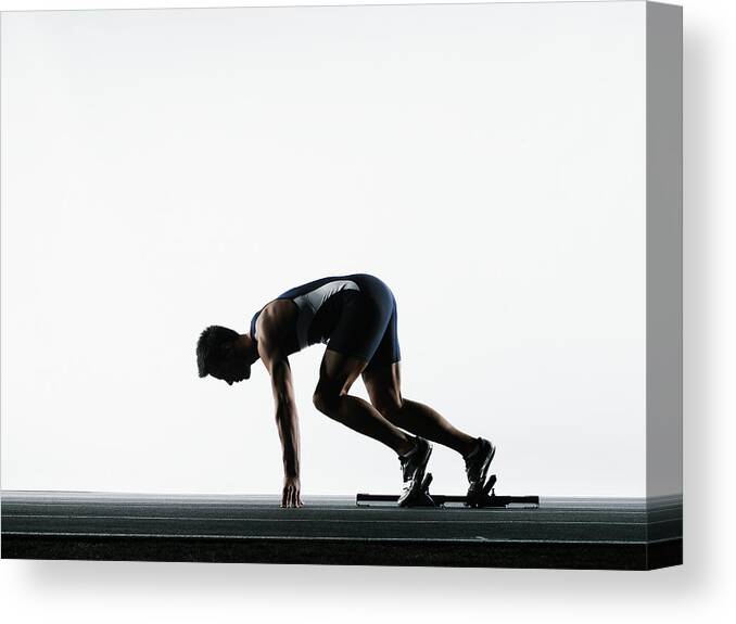 Shadow Canvas Print featuring the photograph Male Runner In Starting Block by Thomas Barwick