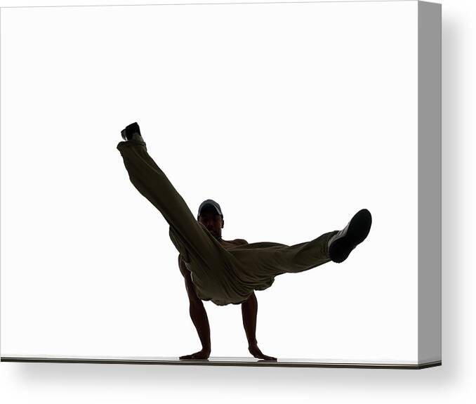 White Background Canvas Print featuring the photograph Silhouette Of Male Breakdancer by John Lamb