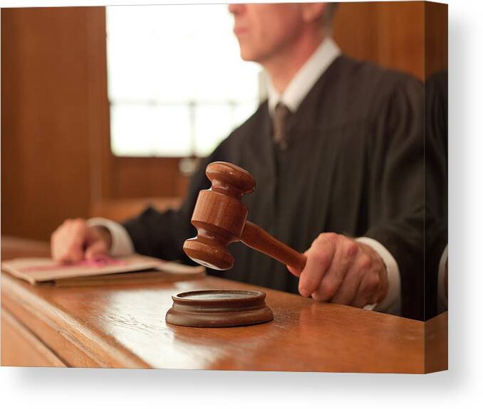 Mature Adult Canvas Print featuring the photograph Judge holding gavel in courtroom by Chris Ryan