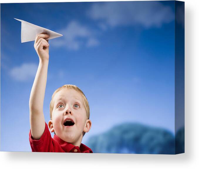 Clear Sky Canvas Print featuring the photograph Boy with paper airplane outdoors by Mike Kemp