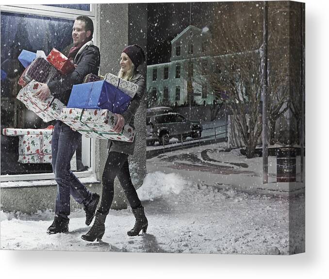 Mid Adult Canvas Print featuring the photograph Couple with Christmas gifts in snow by KMM Productions
