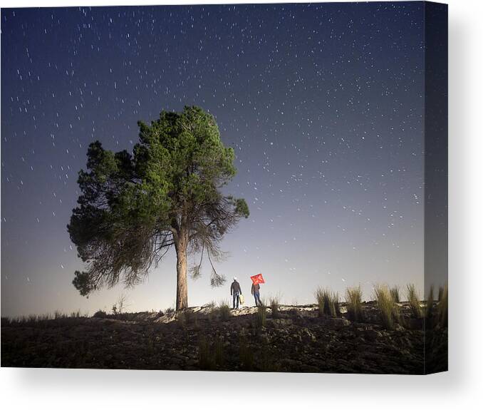 Treetop Canvas Print featuring the photograph Two persons camiando with suitcases in the night by Jose A. Bernat Bacete