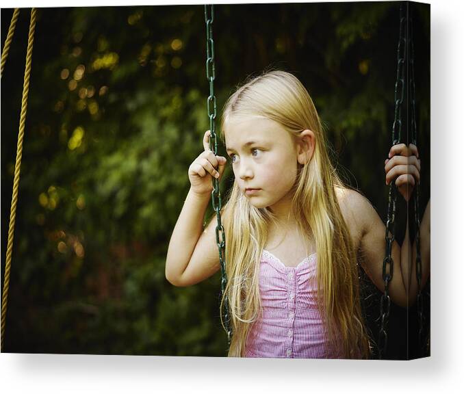 Casual Clothing Canvas Print featuring the photograph Young girl sitting on swing looking out by Thomas Barwick