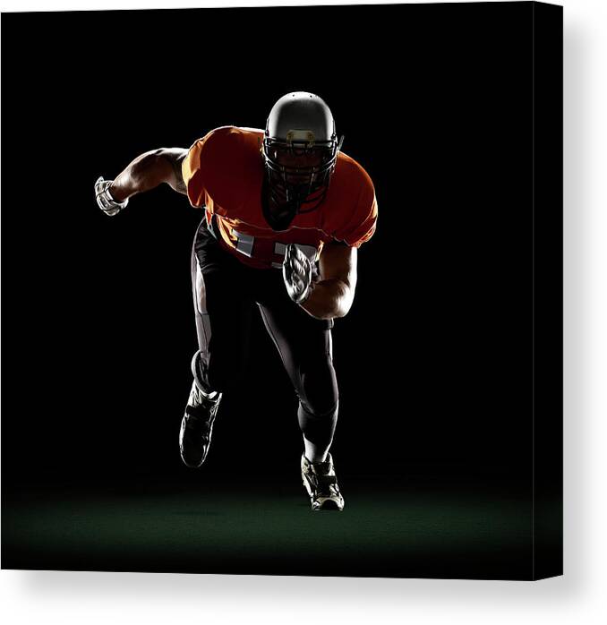 Sports Helmet Canvas Print featuring the photograph Football Player Exploding From 3-point by Lewis Mulatero