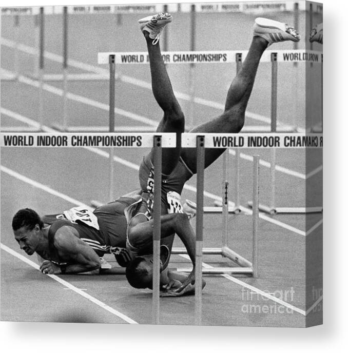 1980-1989 Canvas Print featuring the photograph Runner Tumbles Headfirst Over Hurdles by Bettmann