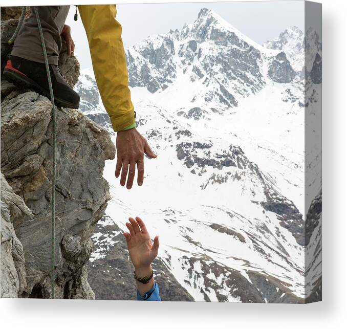 Young Men Canvas Print featuring the photograph Climber Offers Teammate A Helping Hand by Ascent Xmedia