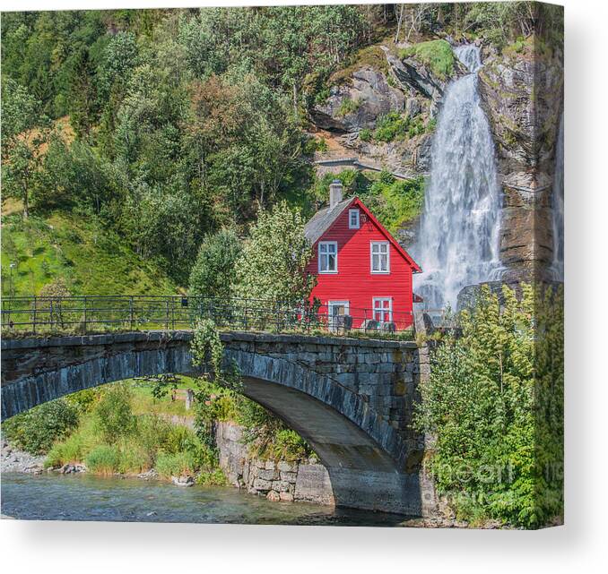 Summer Canvas Print featuring the photograph Red wooden House in front of a Waterfall in Norway by Amanda Mohler