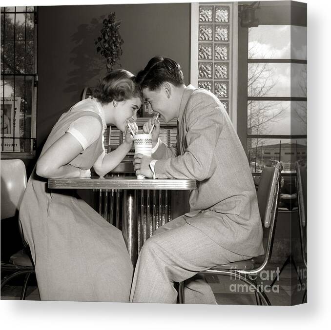 1950s Canvas Print featuring the photograph Laughing Couple Sharing A Drink by H. Armstrong Roberts/ClassicStock
