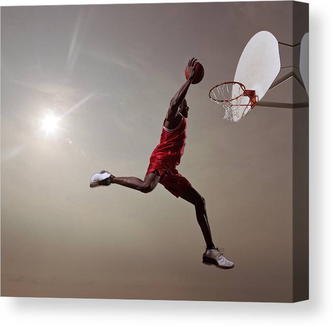 One Man Only Canvas Print featuring the photograph Basketball Player In Mid-air Jump by Blake Little