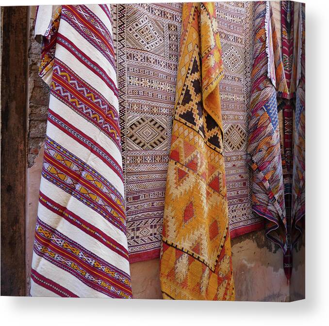 Bright Colored Canvas Print featuring the photograph Bright colored patterns on throw rugs in the medina bazaar by Steve Estvanik