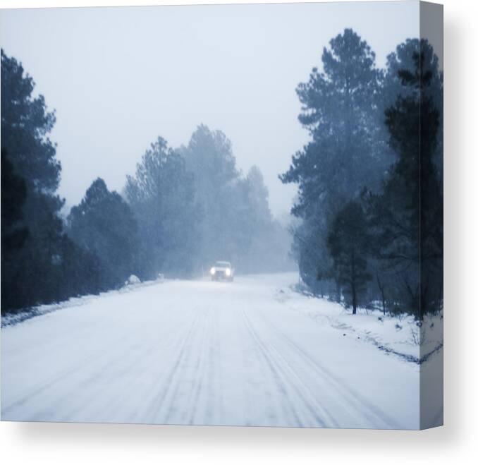 Scenics Canvas Print featuring the photograph Defocused Car driving in snow along rural road by Lyn Holly Coorg