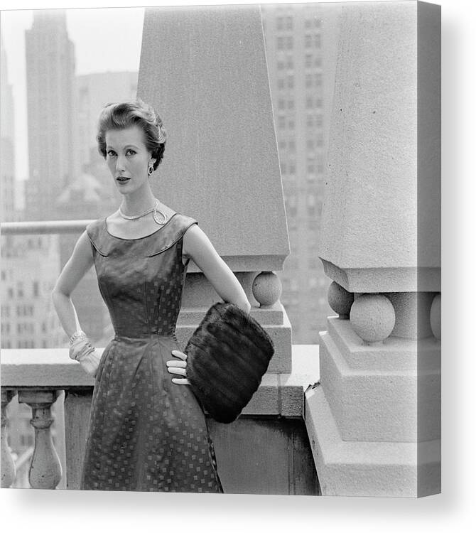 Skyline Canvas Print featuring the photograph A Model Standing Against A Rooftop Column In An #1 by Richard Rutledge