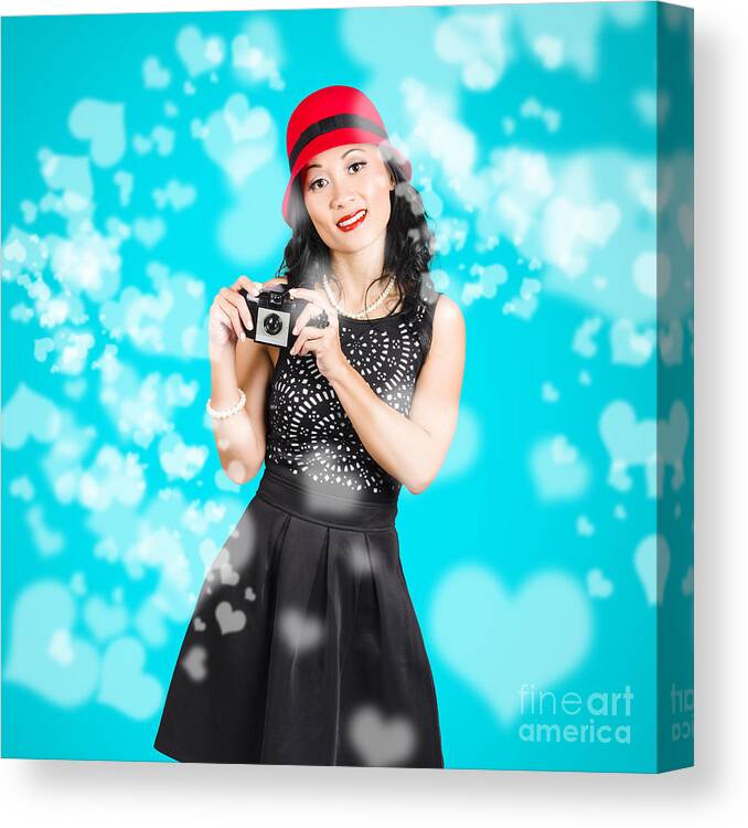 Camera Canvas Print featuring the photograph Young woman holding retro camera on blue #1 by Jorgo Photography