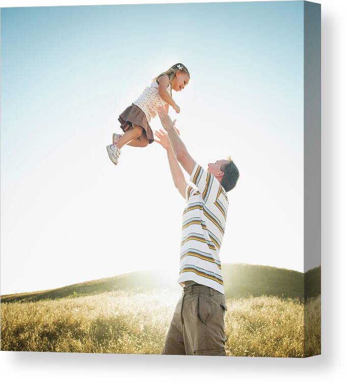 Human Arm Canvas Print featuring the photograph Caucasian Father Lifting Daughter by Erik Isakson
