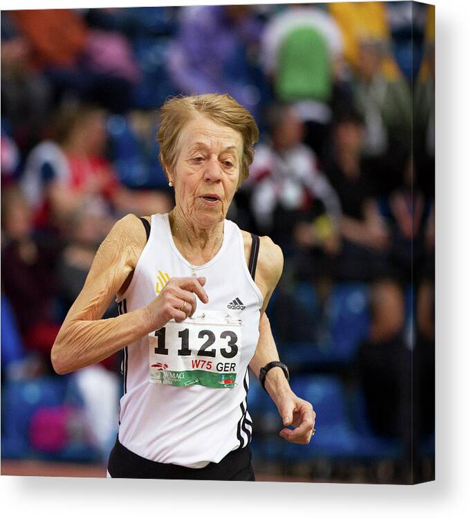One Person Canvas Print featuring the photograph Elderly Female Athlete In Competition by Alex Rotas