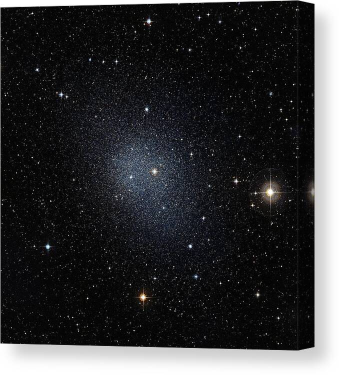 Fornax Dwarf Galaxy Canvas Print featuring the photograph Fornax Dwarf Galaxy by European Southern Observatory/science Photo Library
