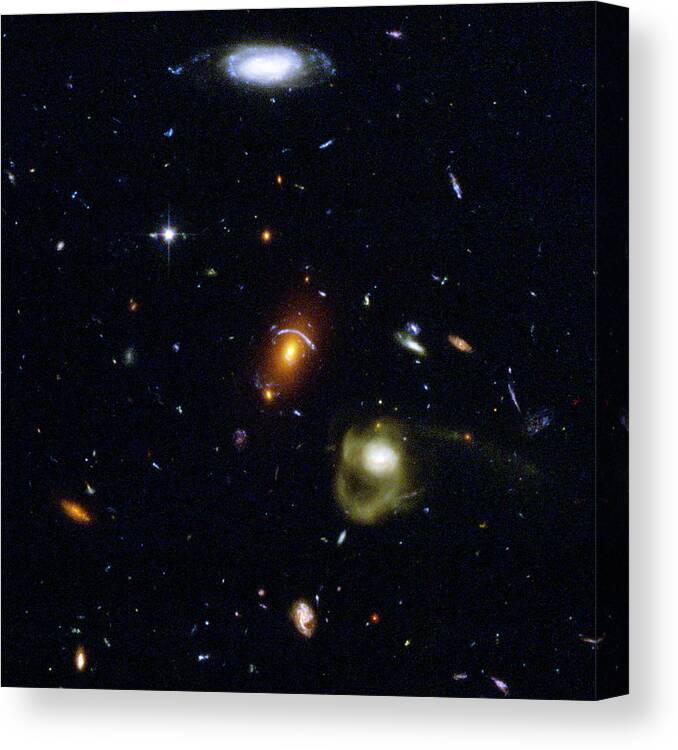 Galaxy Canvas Print featuring the photograph Gravitational Lensing Between Galaxies by Nasa/esa/stsci/j.blakeslee & H.ford, Jhu/ Science Photo Library