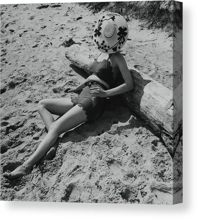 Accessories Canvas Print featuring the photograph Model Covering Her Face With Hat On Beach by Toni Frissell