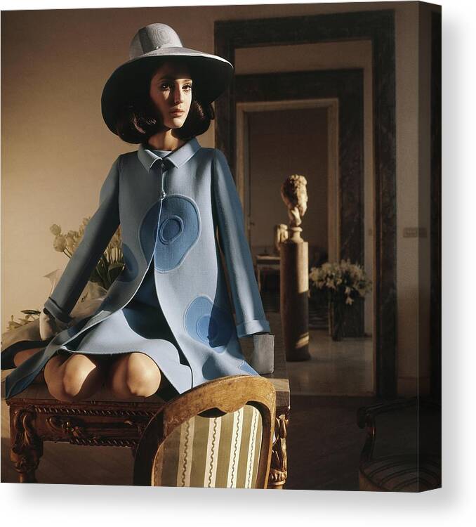 Interior Canvas Print featuring the photograph Model Sitting On A Desk Wearing A Double-faced by Henry Clarke