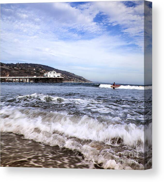 Malibu Beach Pier Photographs Canvas Print featuring the photograph Ocean Waves Blue Sky And A Surfer At Malibu Beach Pier by Jerry Cowart