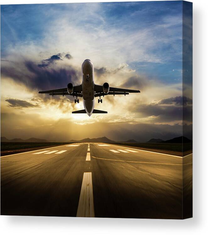Taking Off Canvas Print featuring the photograph Passenger Airplane Taking Off At Sunset by Guvendemir