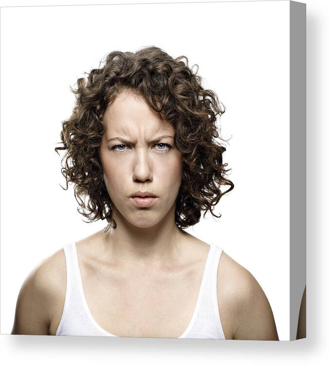 People Canvas Print featuring the photograph Portrait of young woman looking angry by Klaus Vedfelt
